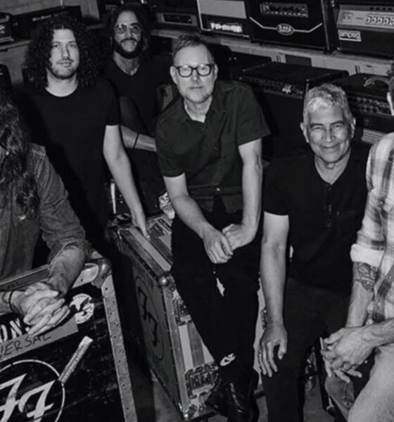 The members of Foo Fighters, including Dave Grohl, backstage with their equipment cases.