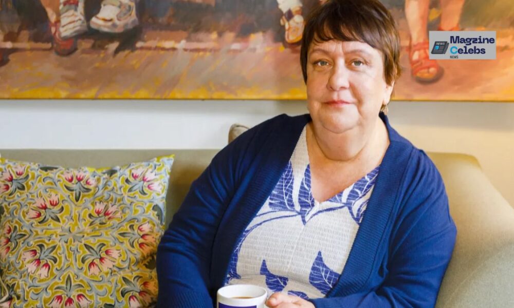 Comedian Kathy Burke sitting comfortably on a sofa, discussing her views on motherhood and gender.