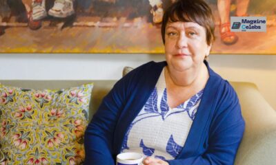 Comedian Kathy Burke sitting comfortably on a sofa, discussing her views on motherhood and gender.
