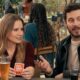 Bell and Adam Brody in a scene from the Netflix series 'Nobody Wants This', sitting at a table.