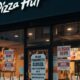 A Pizza Hut restaurant in the UK with a 'Closing Down' sign on the window, illustrating the news of 68 locations shutting down.