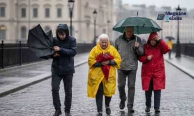 People struggle with umbrellas in heavy rain and wind as Storm Benjamin approaches the UK.